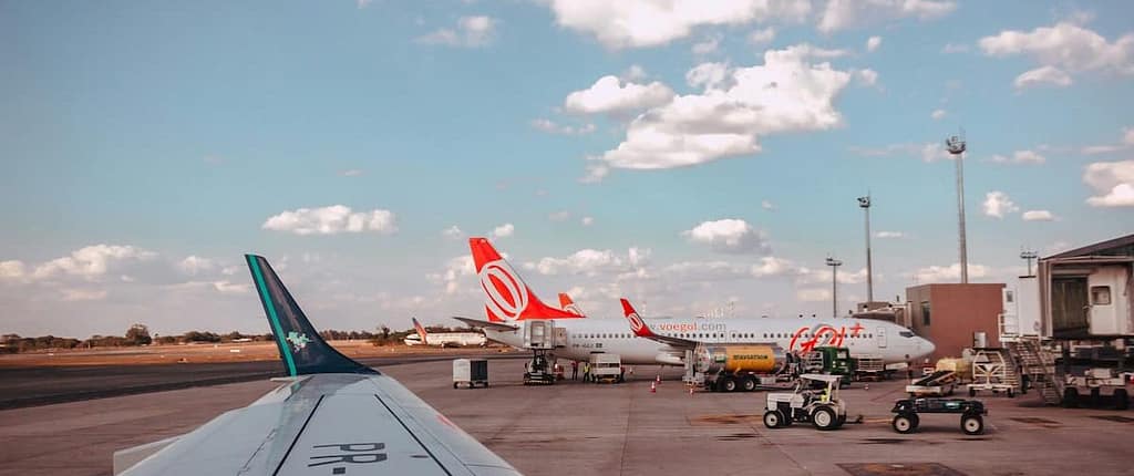 airplanes on tarmac blue sky