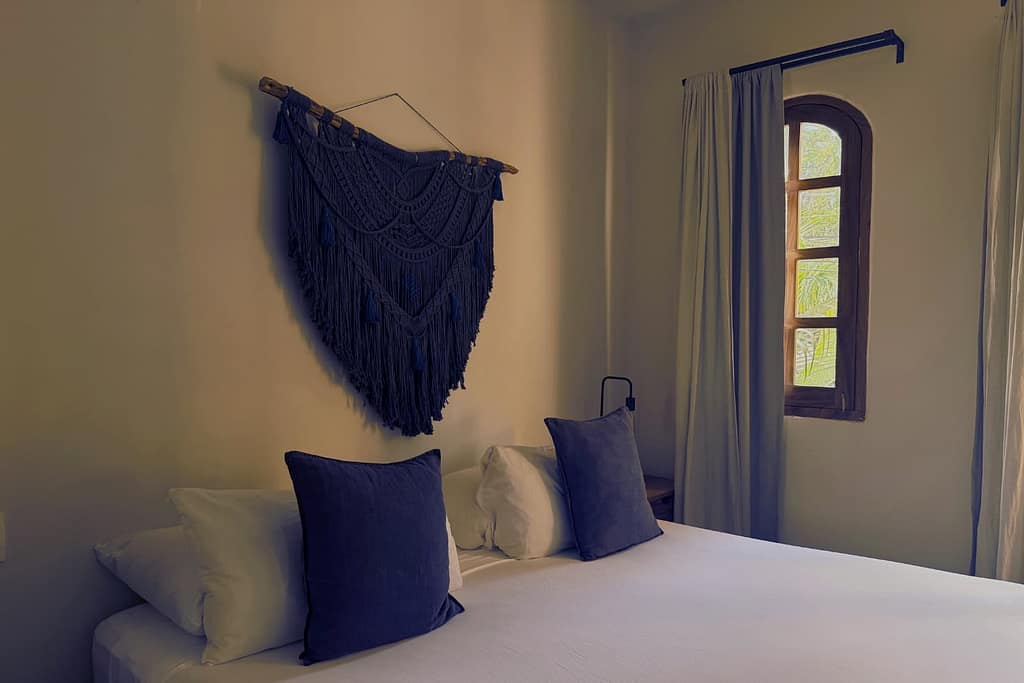 wall weaving and bed in pal gallo suite in pal.mar hotel