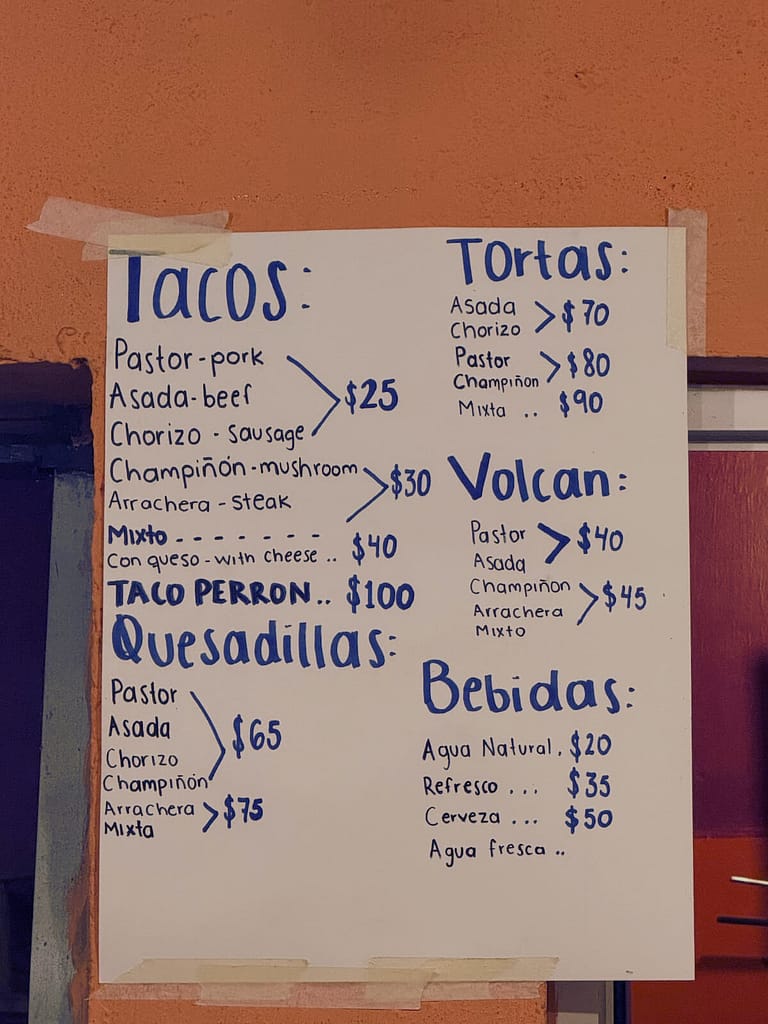 hand-written menu at the taco cart on the corner of Avenida Tercer Mundo and America Latina
